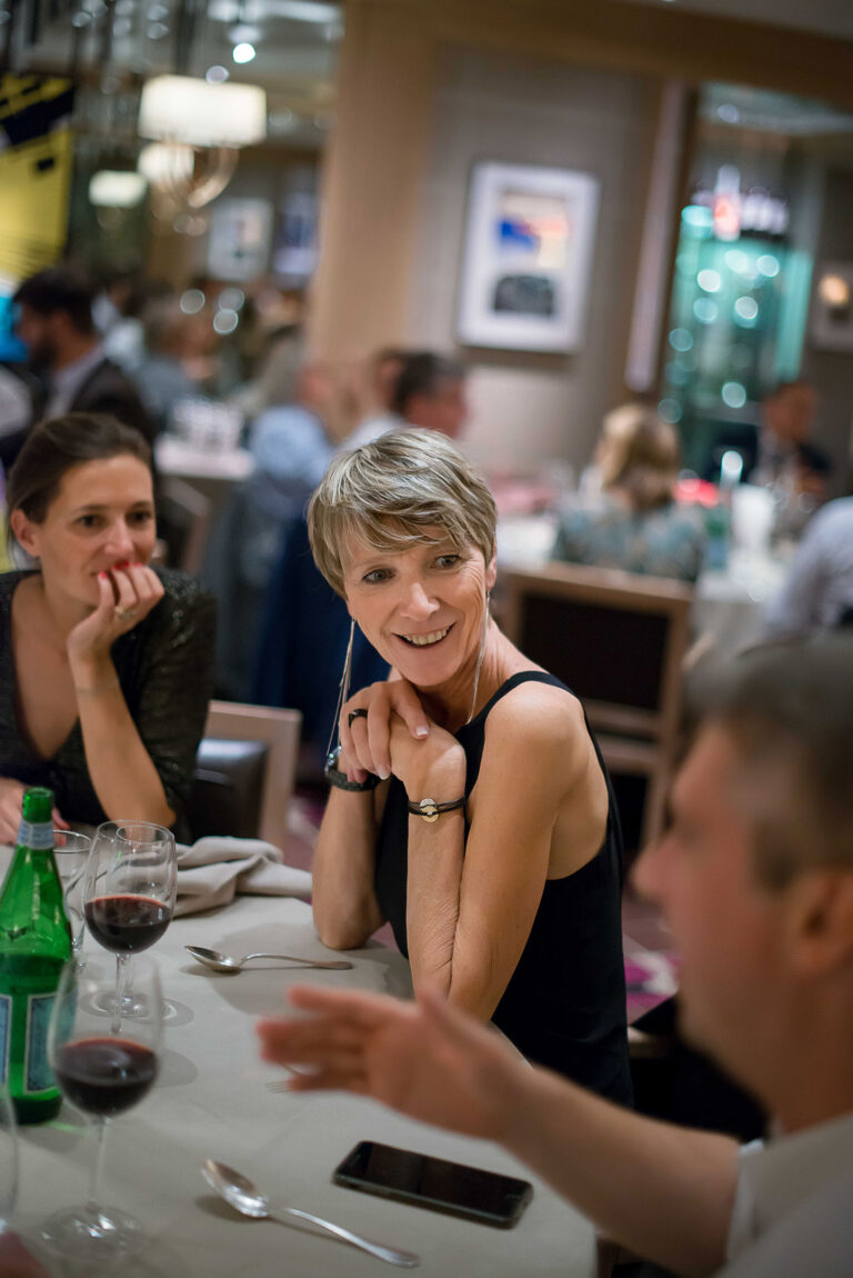 Photographe corporate conférence Côte d’Azur: Portrait élégant d’une invitée savourant la soirée.