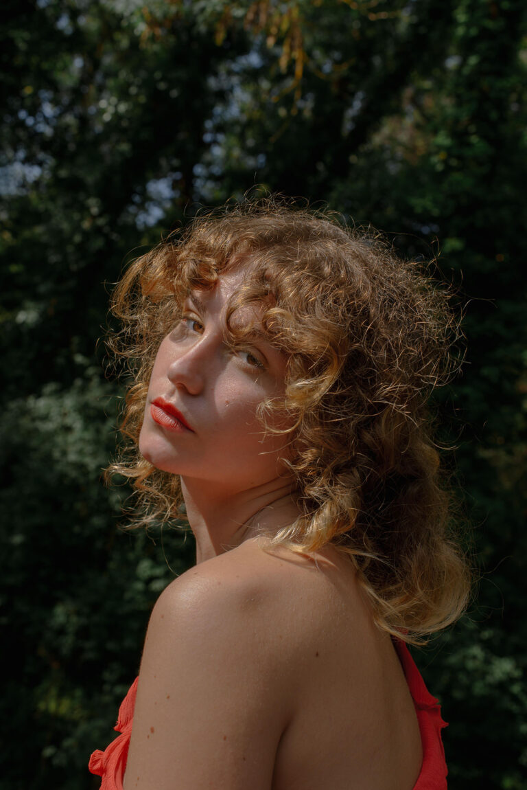 Lumière douce sur les boucles dorées de Silvia, effet cheveux d’ange – Portrait d’ambiance naturelle à Antibes.