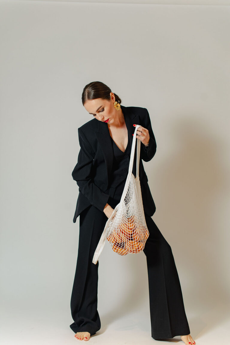 Portrait féminin décalé avec sac filet rempli de croissants.